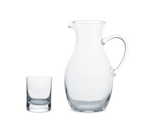 Empty glass and jug isolated on white