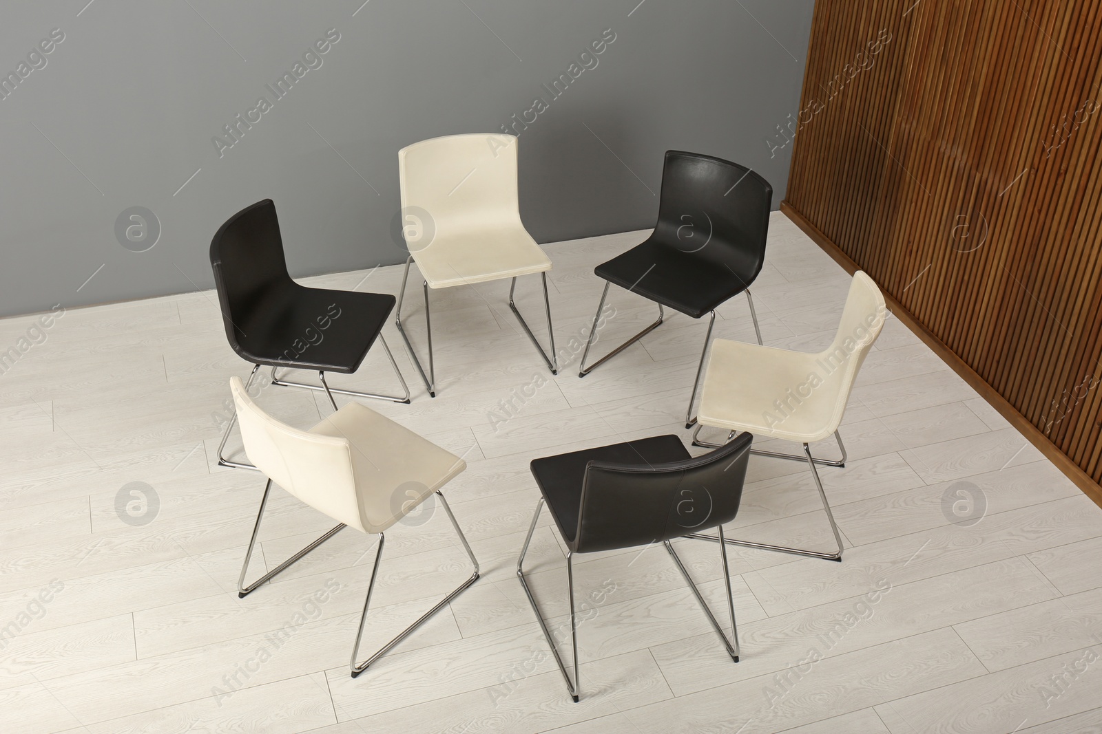 Photo of Chairs prepared for group therapy session in office. Meeting room interior