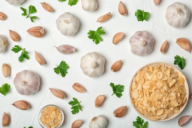 Flat lay composition with garlic products on white background