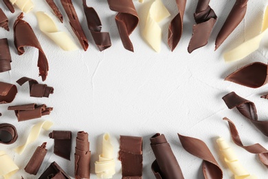 Photo of Flat lay composition with chocolate curls and space for text on light background