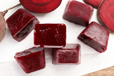 Photo of Frozen beetroot puree cube and fresh beetroot on white background, top view