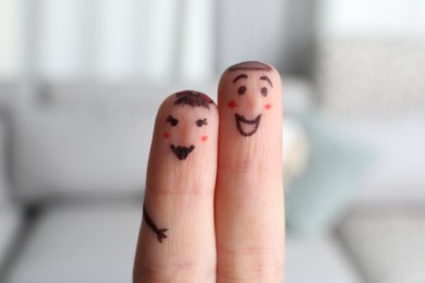 Photo of Two fingers with drawings of happy faces on blurred background. Spending time together