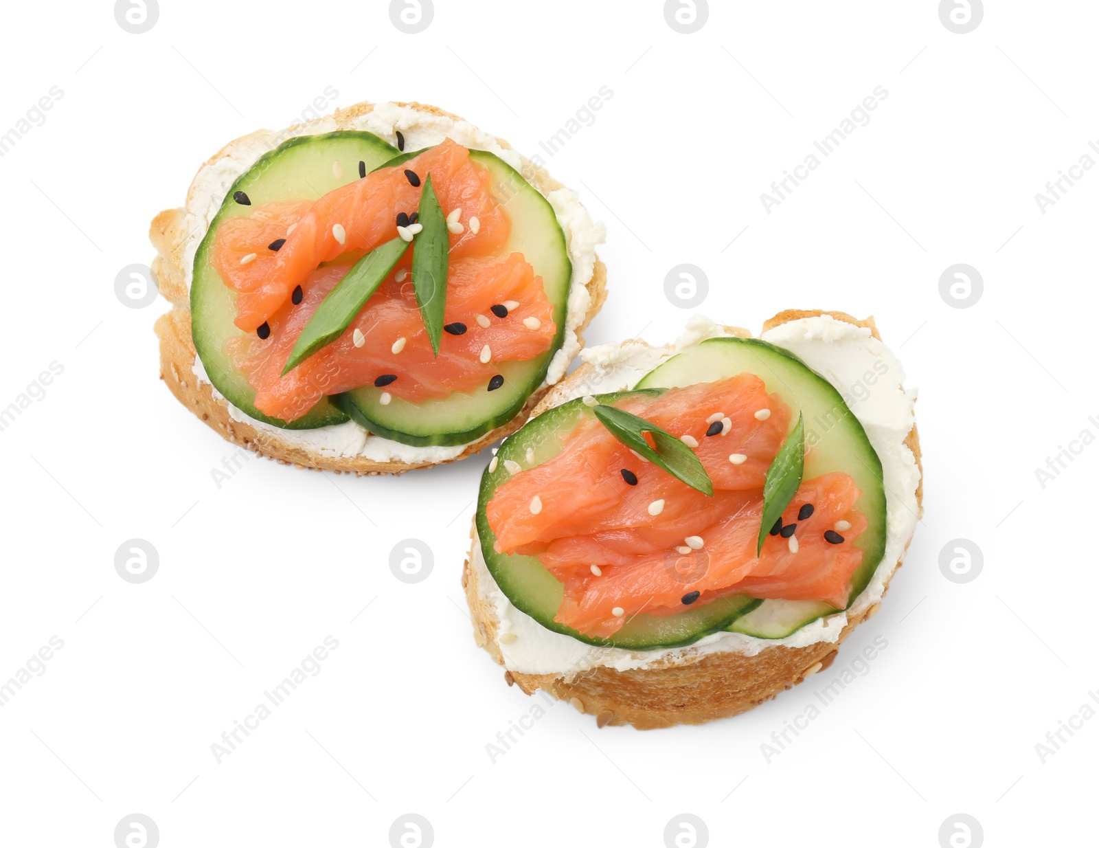 Photo of Tasty canapes with salmon, cucumber and cream cheese isolated on white, top view