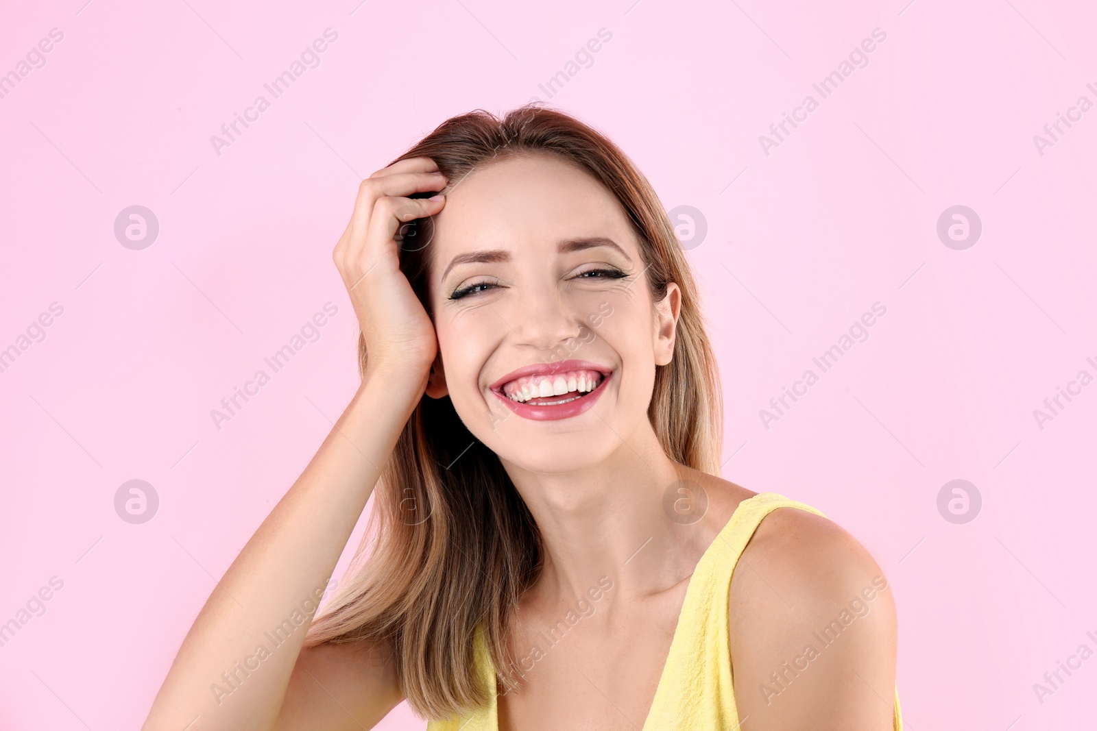 Photo of Portrait of beautiful laughing woman on color background