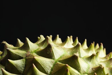 Ripe durian on black background, closeup. Space for text
