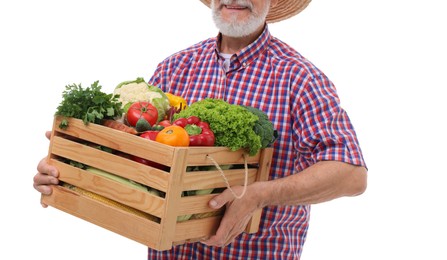 Photo of Harvesting season. Happy farmer holding wooden crate with vegetables on white background, closeup