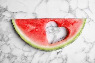 Photo of Slice of watermelon on marble background, top view