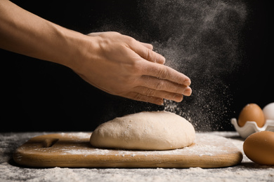 Woman with dough at grey table, closeup. Making pasta