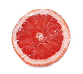 Photo of Half of fresh grapefruit wrapped with transparent plastic stretch film isolated on white