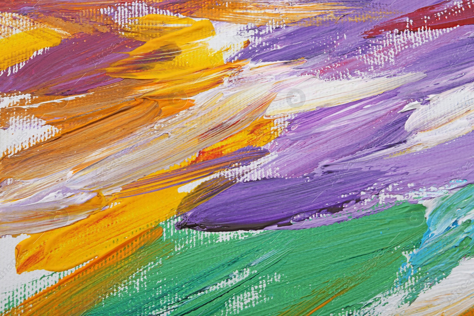 Photo of Beautiful strokes of colorful oil paints on white canvas as background, closeup