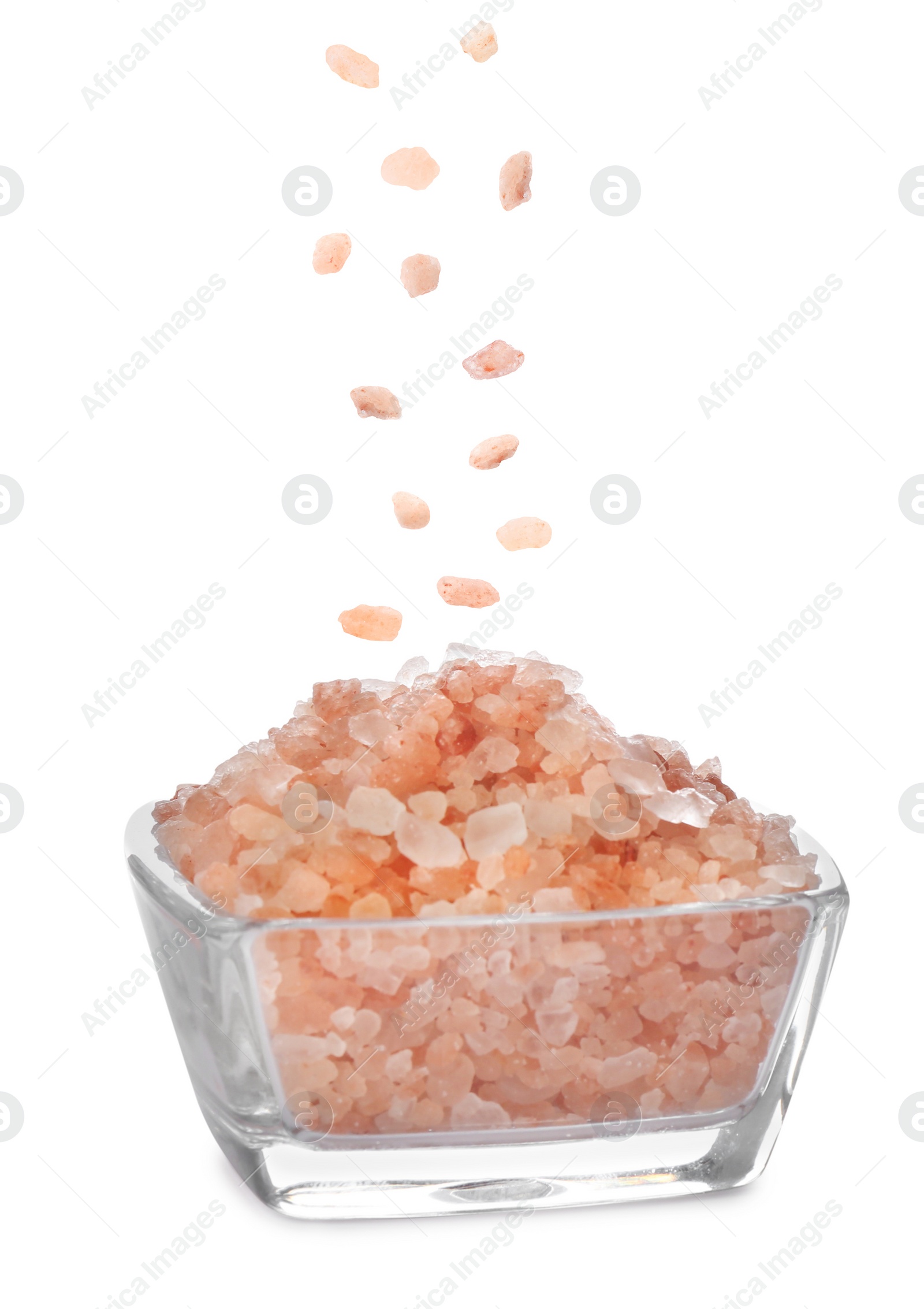 Image of Pink himalayan salt falling into bowl on white background