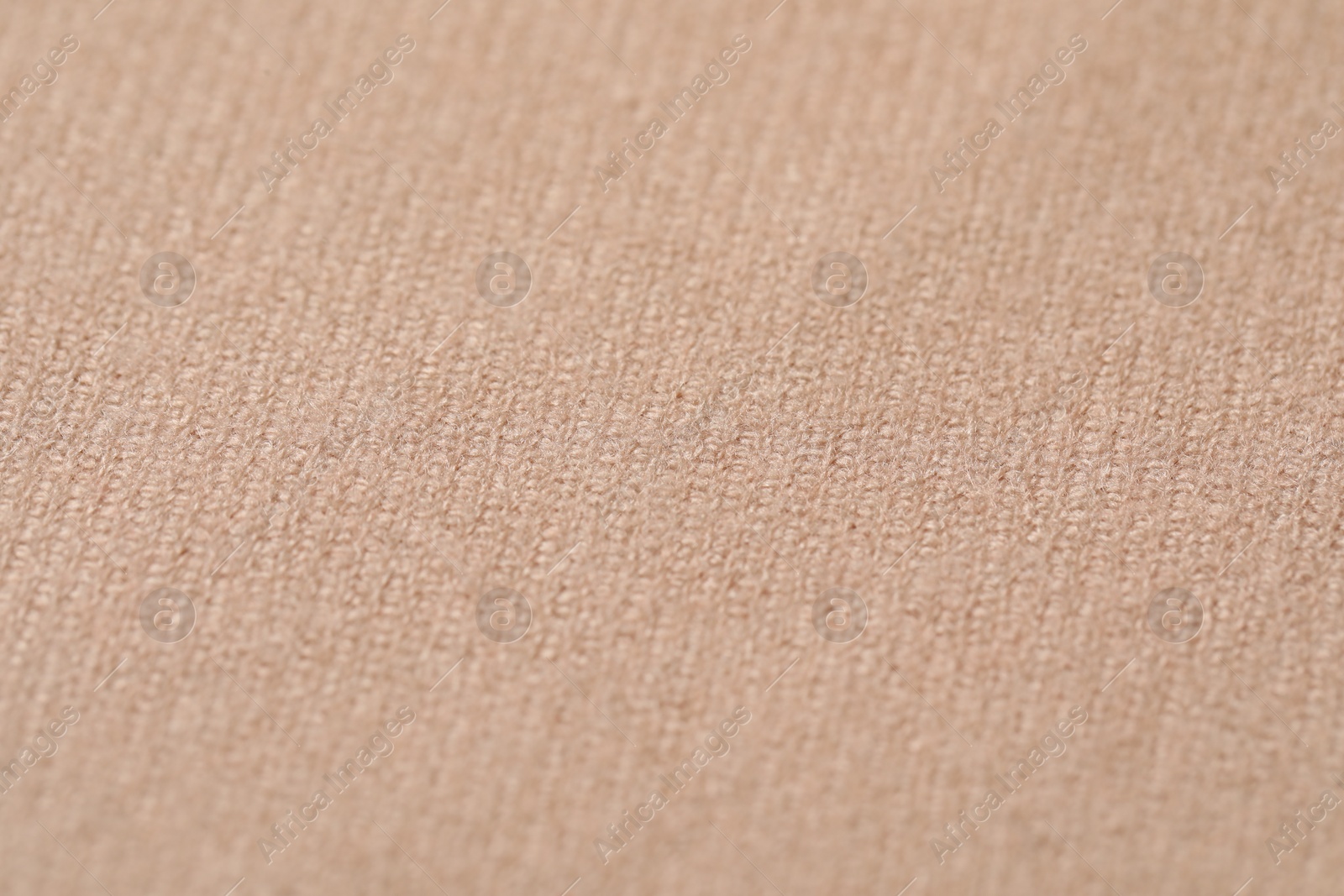 Photo of Texture of soft beige fabric as background, closeup