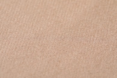 Texture of soft beige fabric as background, closeup