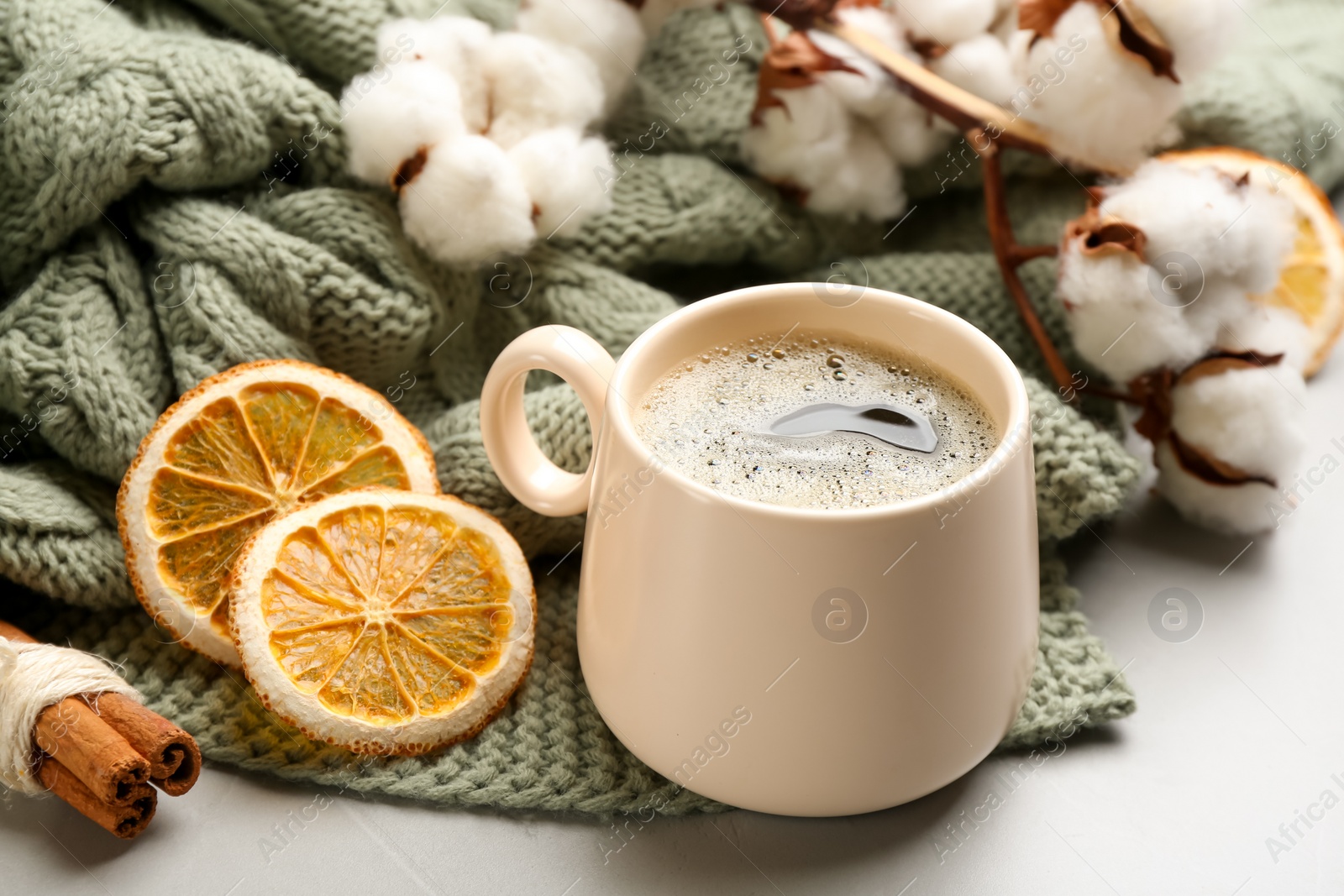 Photo of Composition with hot drink and warm plaid on light table