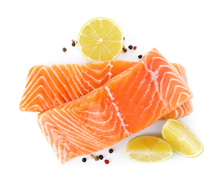 Photo of Fresh raw salmon with pepper, lime and lemon on white background, top view. Fish delicacy
