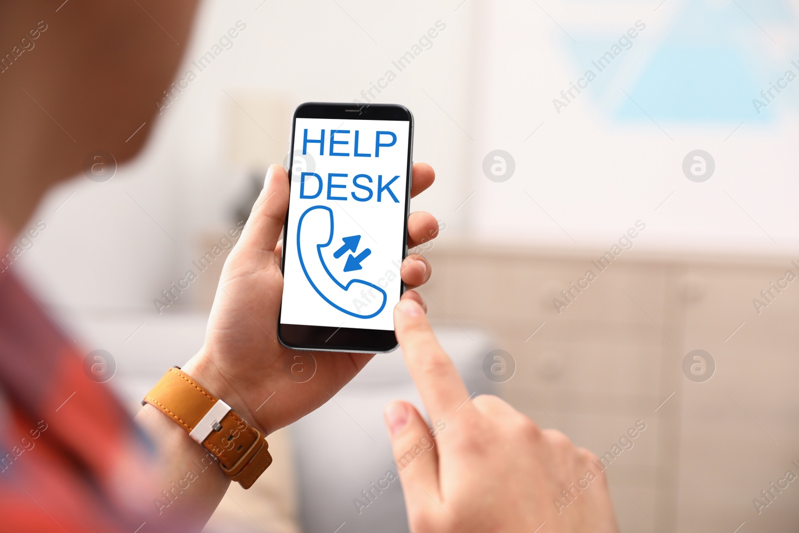 Image of Man calling to help desk service with smartphone indoors, closeup