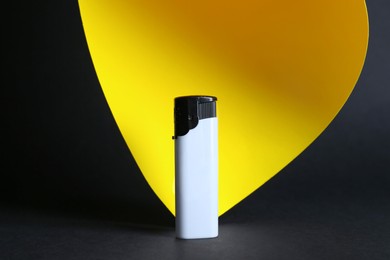 Stylish small pocket lighter on color background