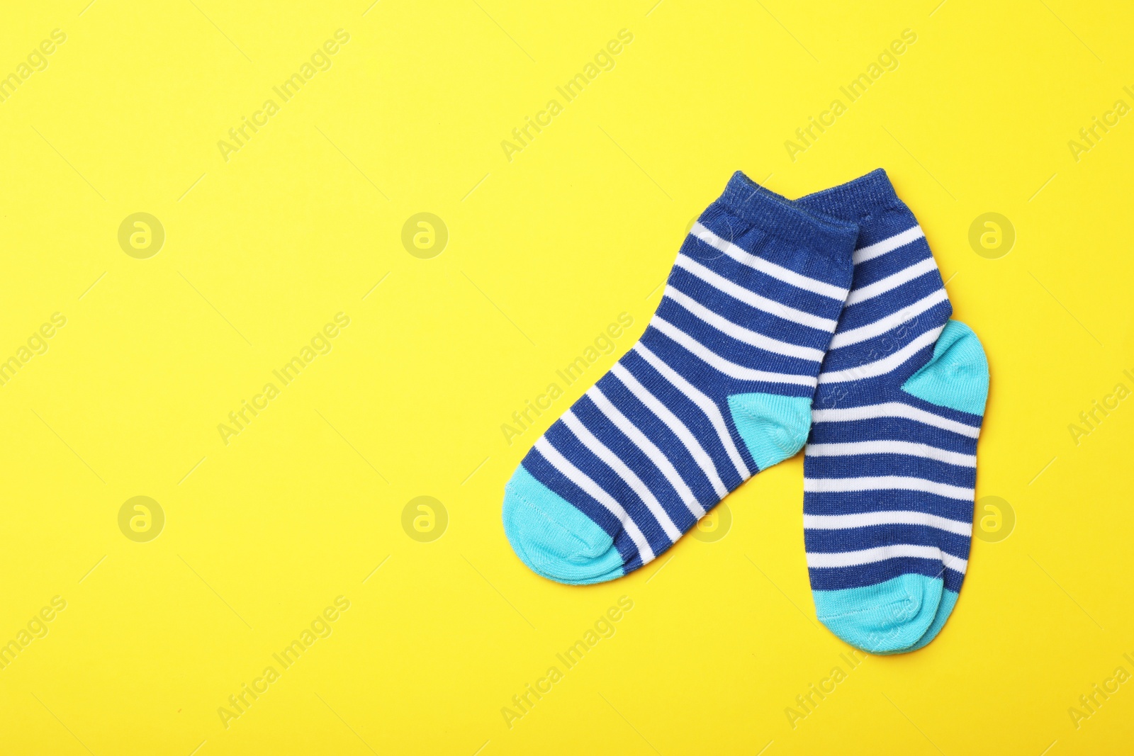 Photo of Cute child socks on color background, flat lay. Space for text