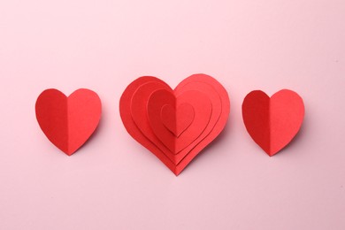 Photo of Paper hearts on pink background, flat lay