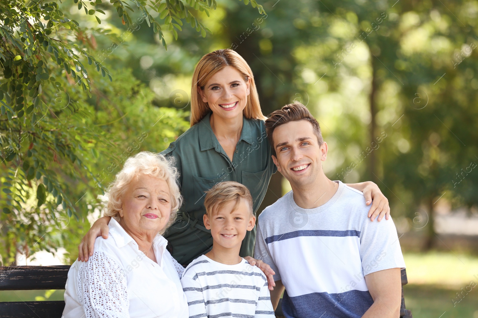 Photo of Couple with child and elderly woman in park