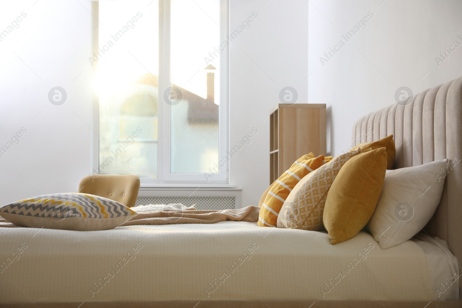 Photo of Comfortable bed with soft pillows in stylish room interior