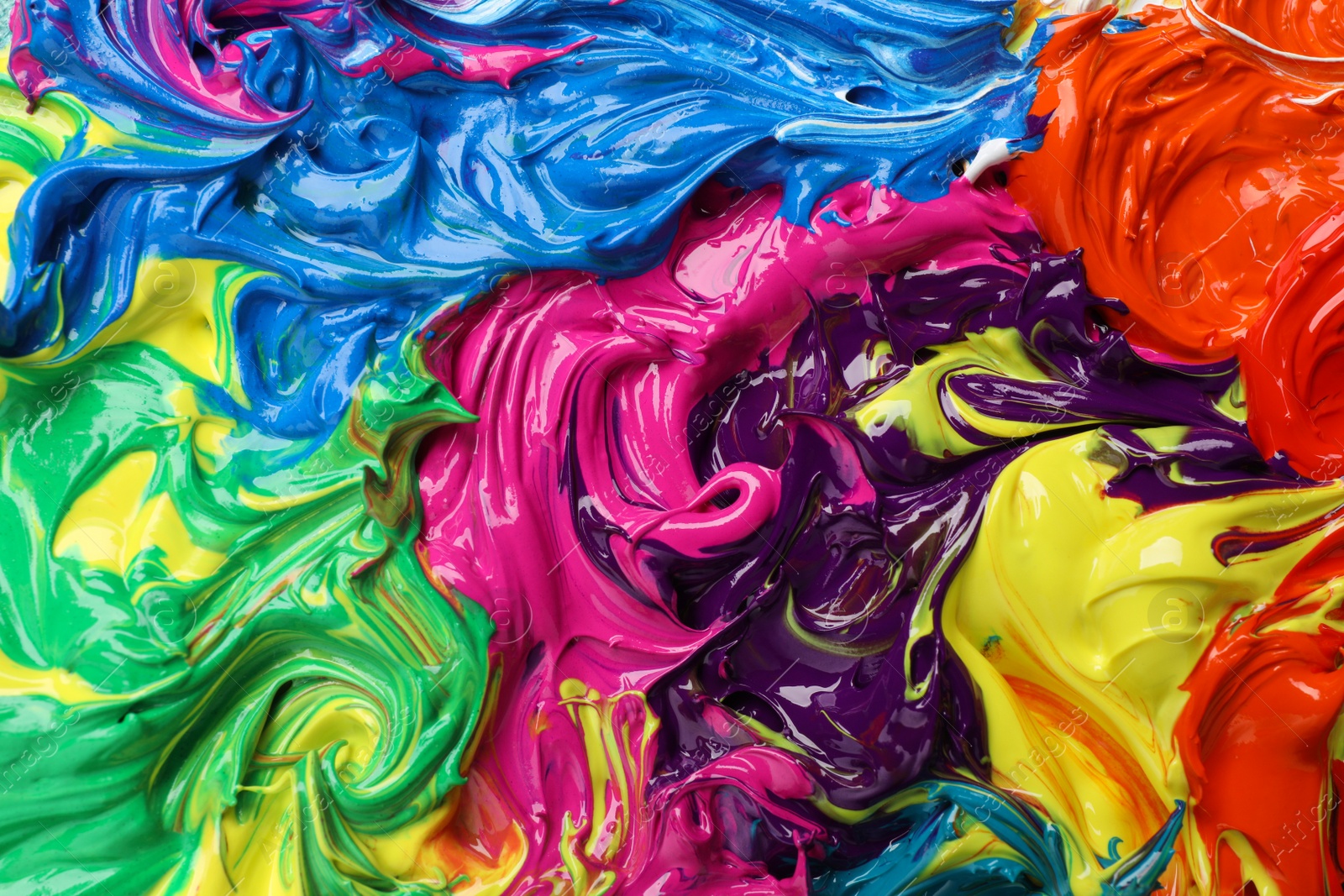 Photo of Mixed colorful acrylic paints as background, closeup view