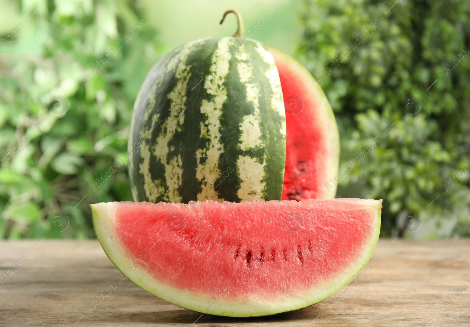 Photo of Tasty ripe cut watermelon on wooden table