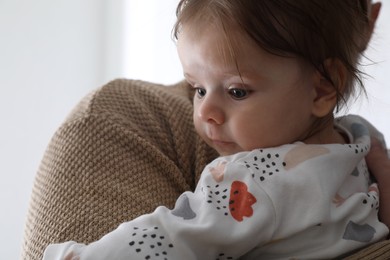 Photo of Father holding his daughter indoors, closeup view