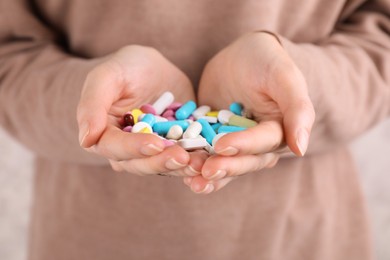 Photo of Woman holding pile of antidepressants, closeup view