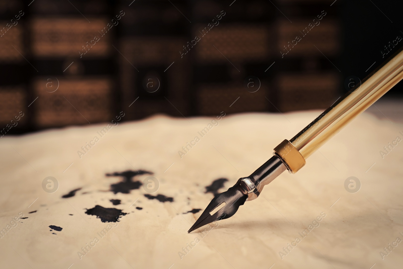 Photo of Fountain pen and vintage parchment with ink stains, closeup. Space for text