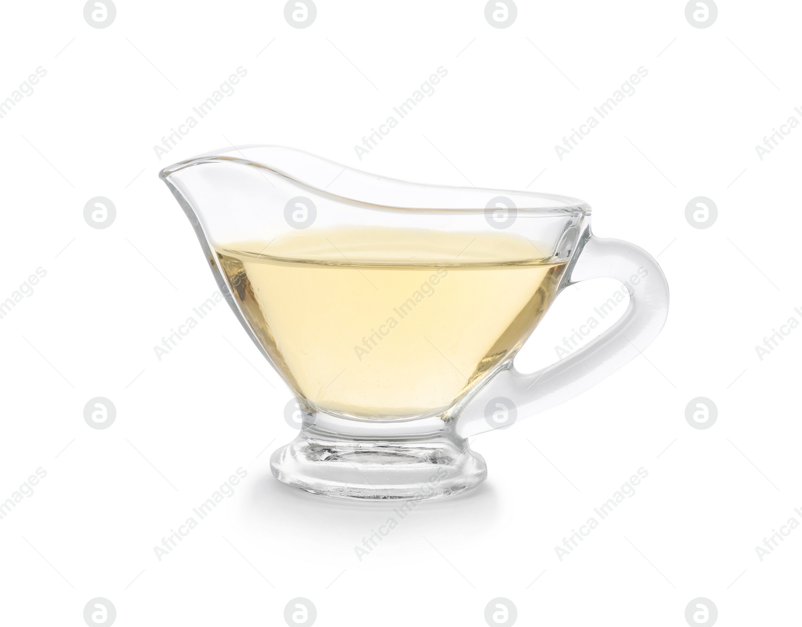Photo of Apple vinegar in glass gravy boat on white background