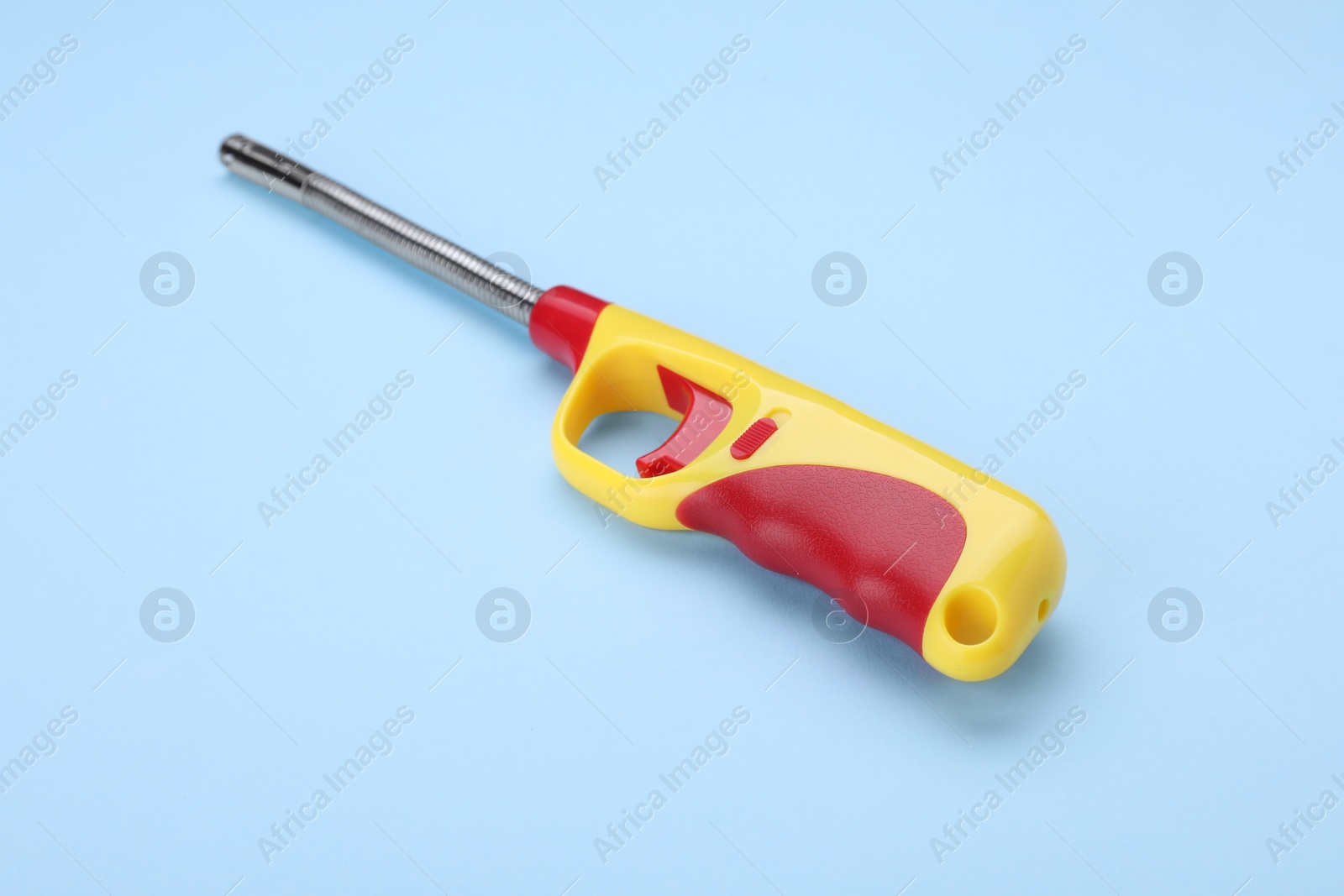 Photo of One gas lighter on light blue background