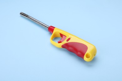 One gas lighter on light blue background