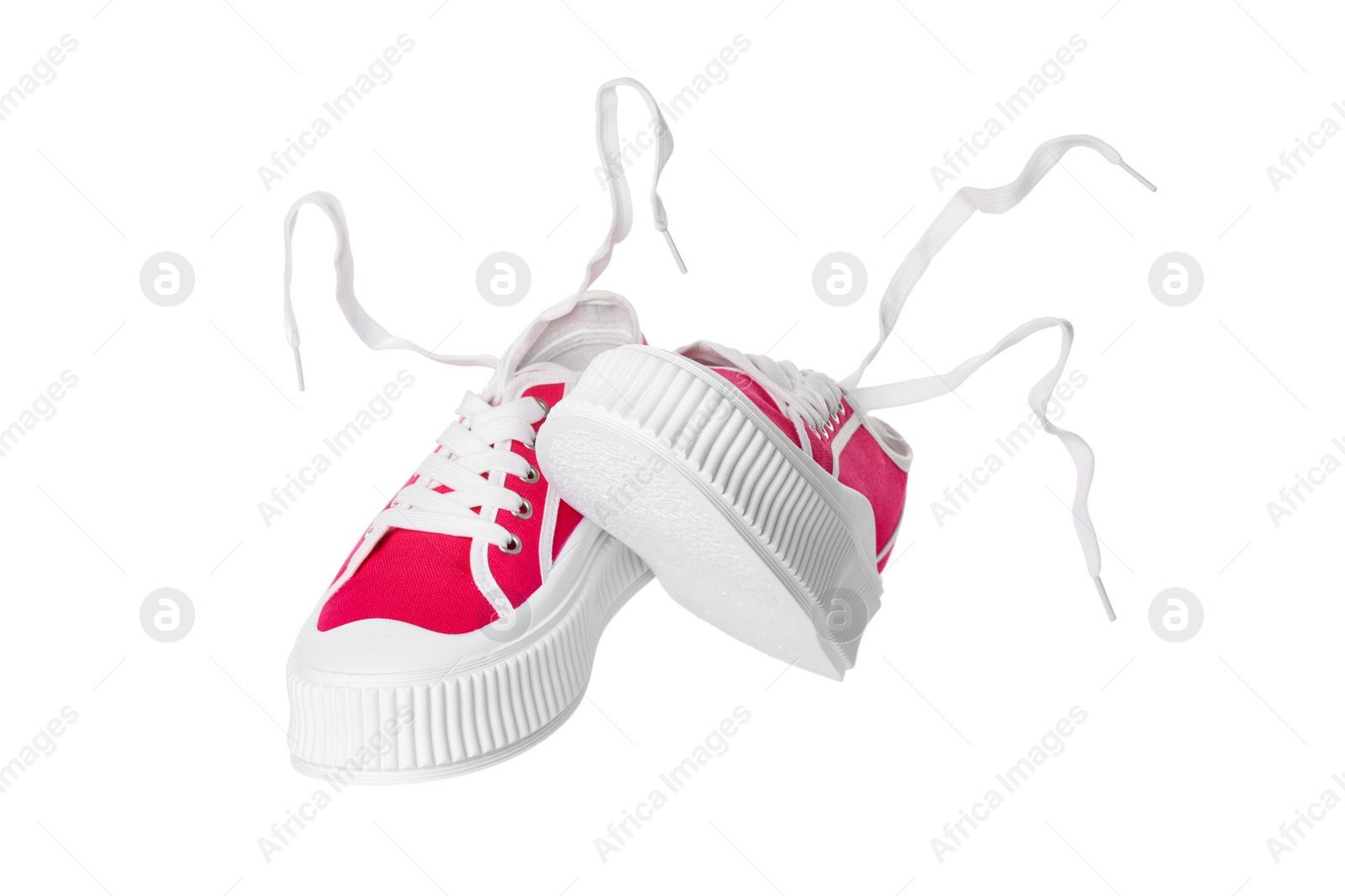 Photo of Pair of red classic old school sneakers on white background