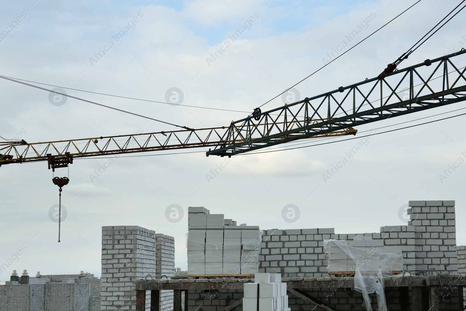 Photo of Construction site with tower crane near unfinished building