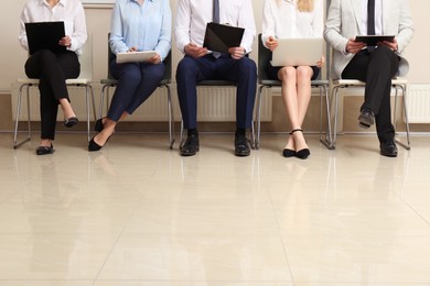 People waiting for job interview in office hall, closeup