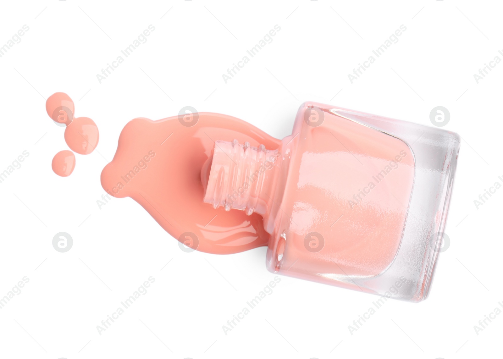 Photo of Overturned bottle of coral nail polish isolated on white, top view