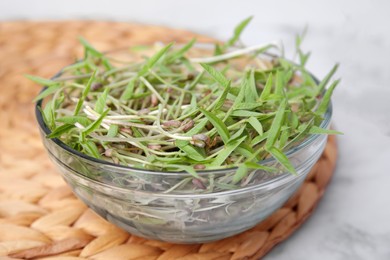 Photo of Mung bean sprouts in glass bowl on table, closeup