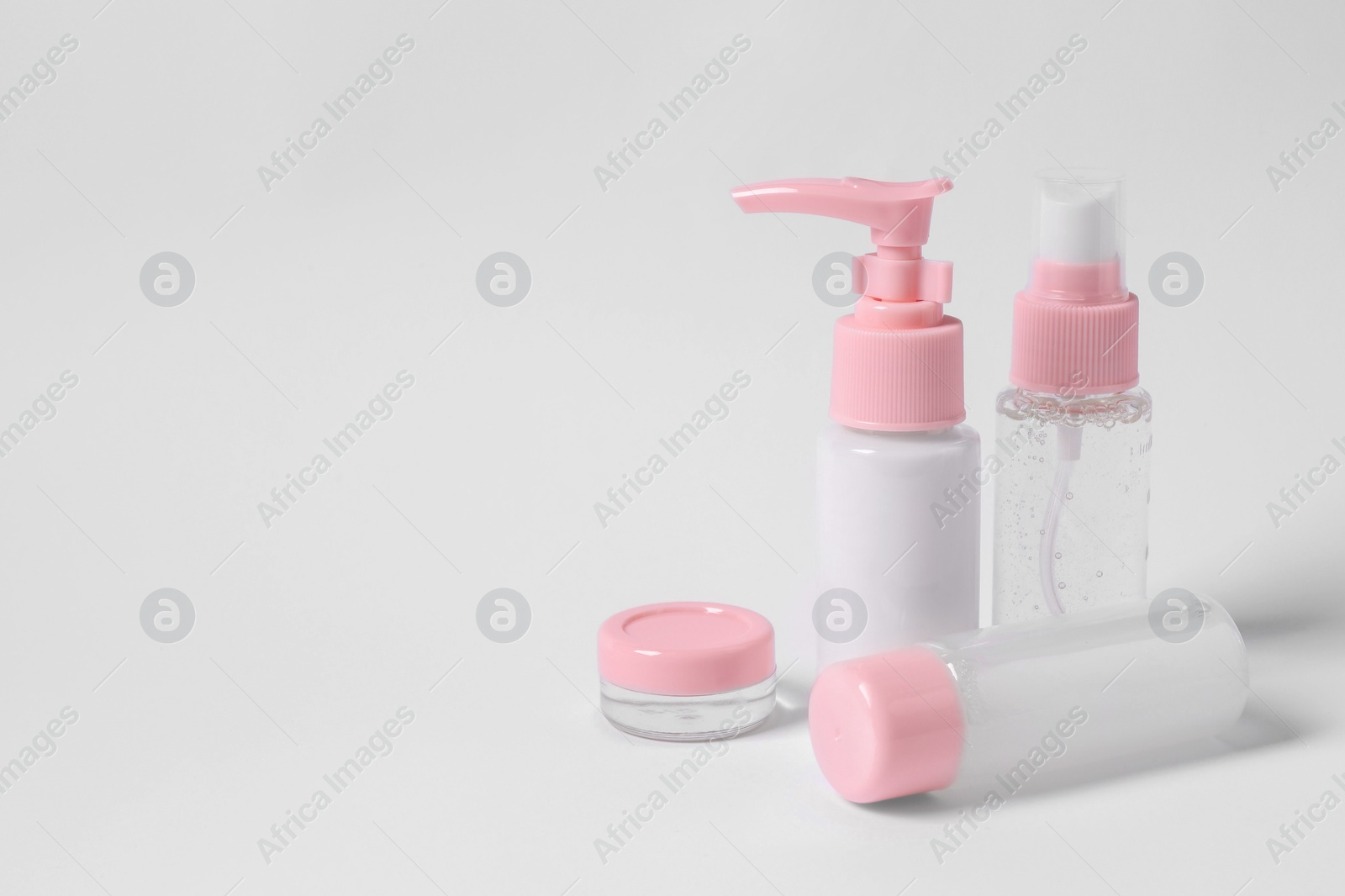 Photo of Cosmetic travel kit on white background. Space for text