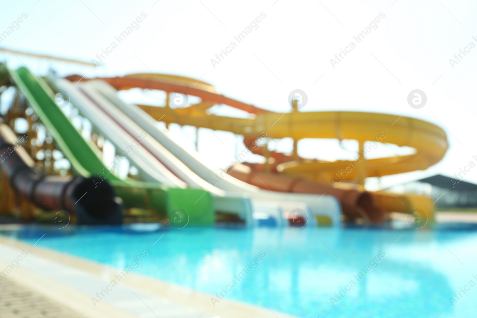 Photo of Different colorful slides in water park, blurred view