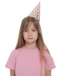 Photo of Unhappy little girl in party hat on white background
