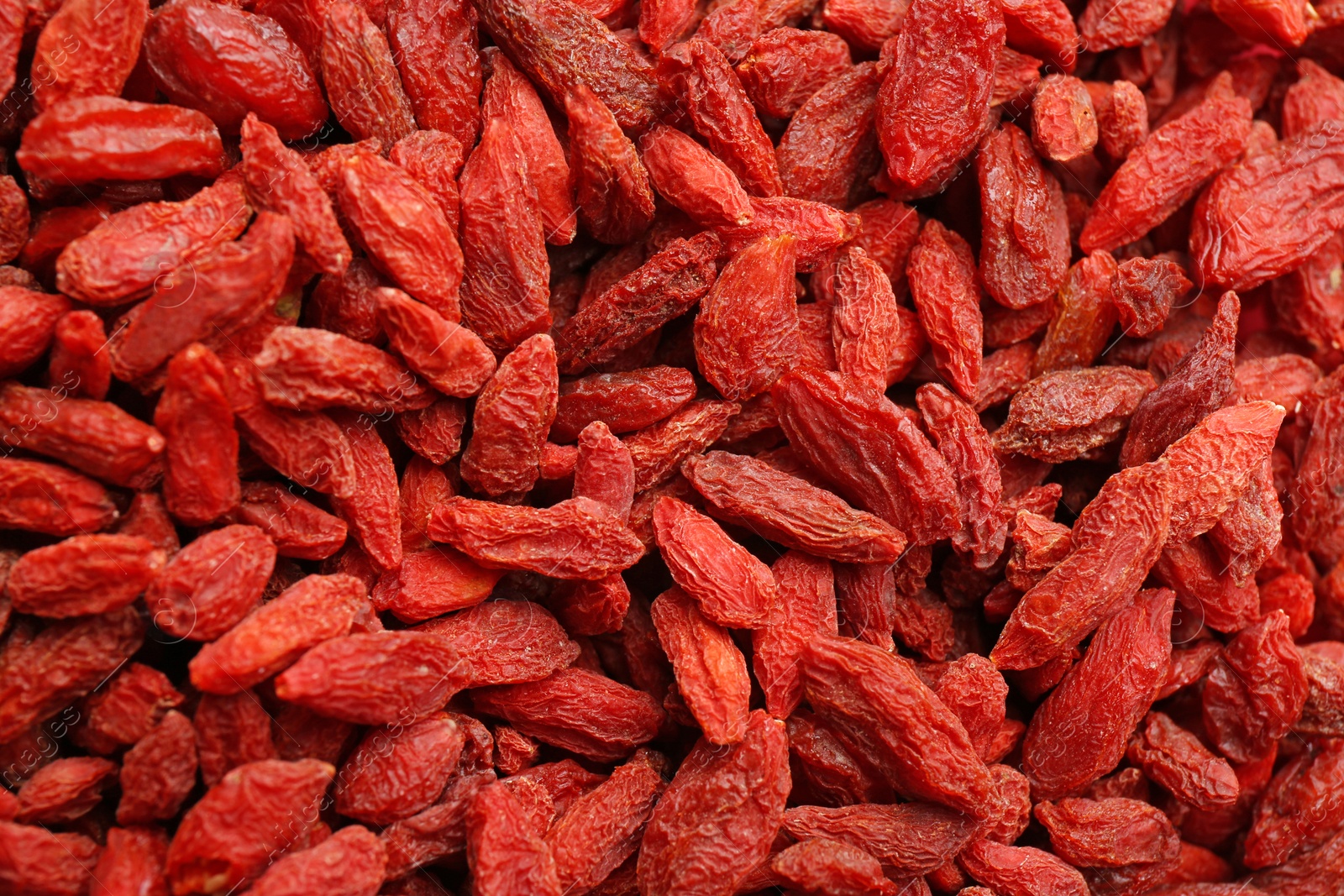 Photo of Many dried goji berries as background, closeup. Healthy superfood