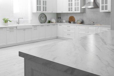 Photo of Stylish white marble countertop in kitchen. Interior design