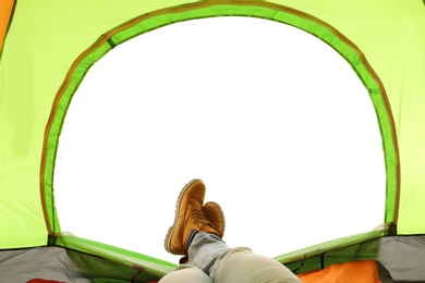 Photo of Closeup of man in camping tent on white background, view from inside