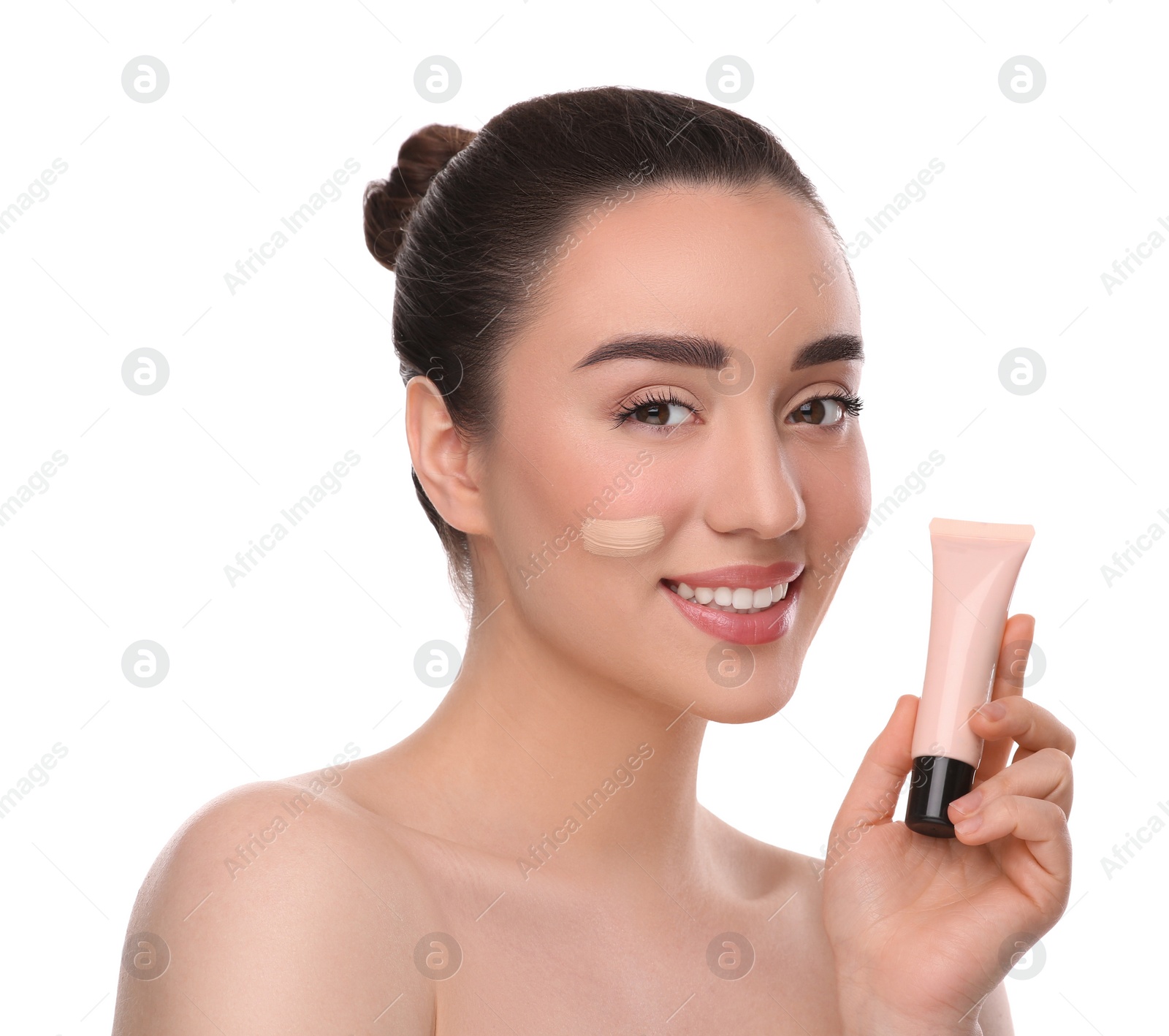 Photo of Woman holding tube of foundation on white background