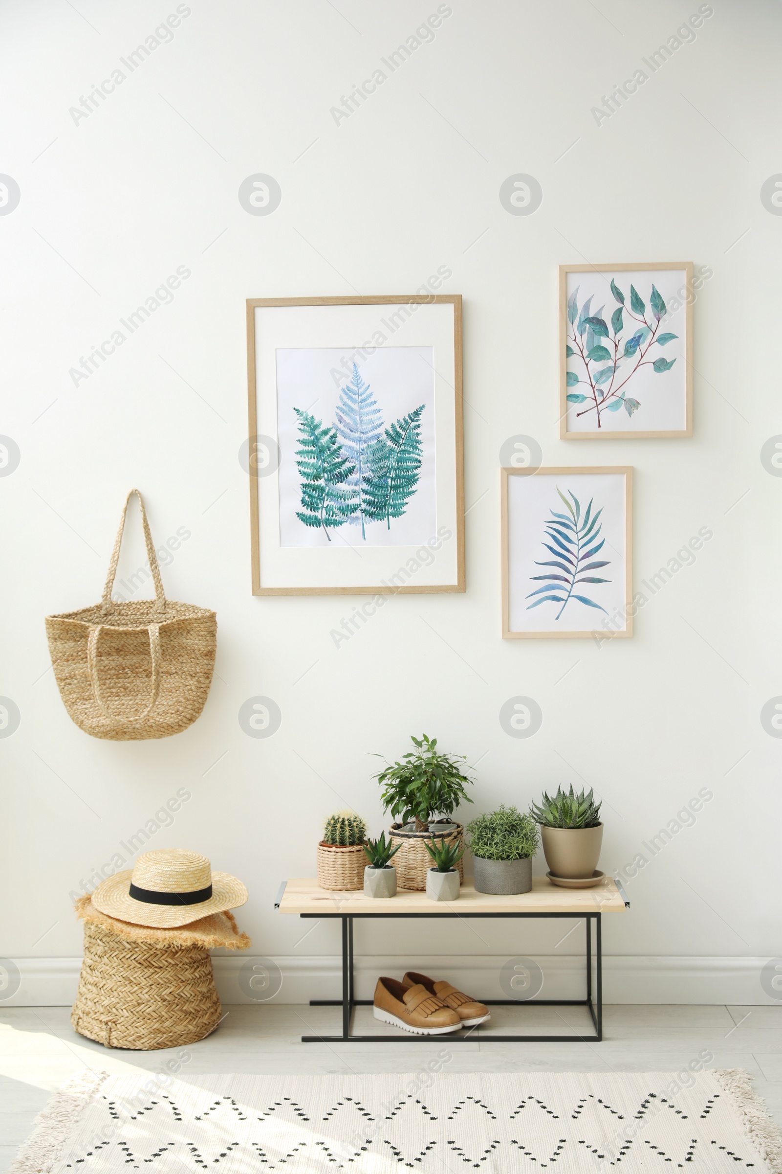 Photo of Beautiful paintings and plants at home. Idea for interior design