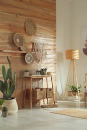 Stylish living room interior with wooden furniture and beautiful houseplants