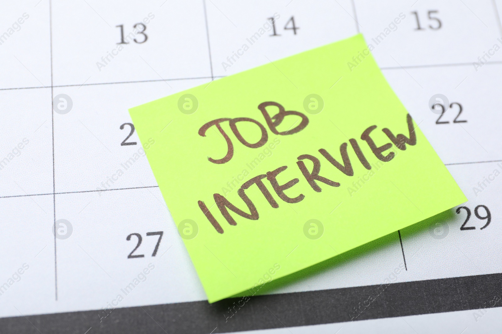 Photo of Reminder note about job interview on calendar, closeup