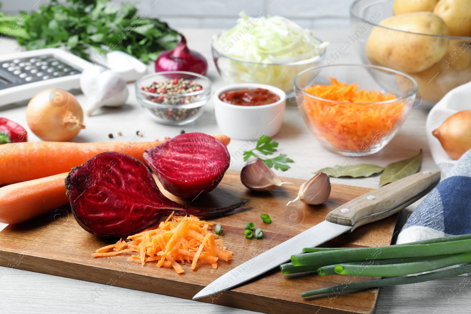 Photo of Fresh ingredients for borscht on white wooden table