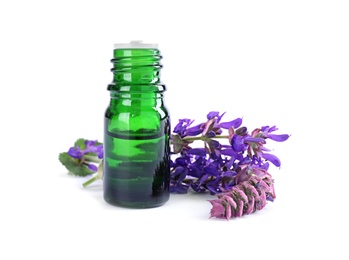 Bottle of herbal essential oil and sage flowers isolated on white